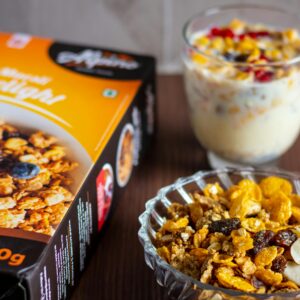 Delicious breakfast setup with nut delight cereal, milk, and fruit parfait.