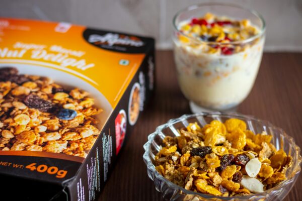 Delicious breakfast setup with nut delight cereal, milk, and fruit parfait.
