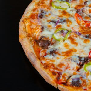 A delicious pepperoni pizza topped with colorful peppers and melted cheese, perfect for a tasty meal.
