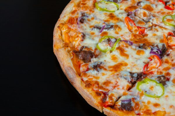 A delicious pepperoni pizza topped with colorful peppers and melted cheese, perfect for a tasty meal.