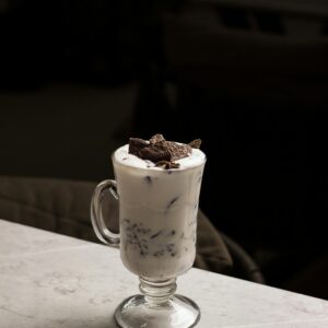 A delicious Oreo milkshake in a glass cup, perfect for dessert lovers.