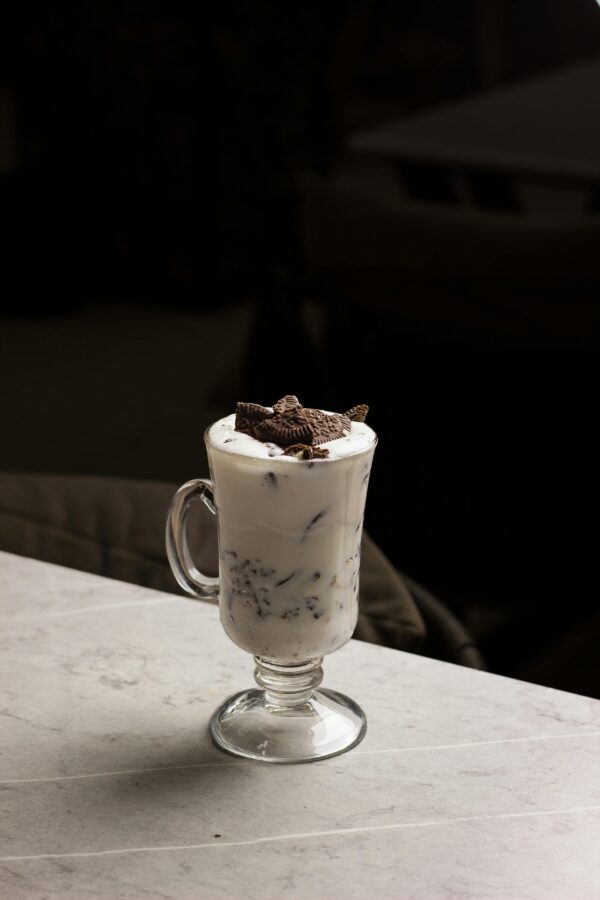 A delicious Oreo milkshake in a glass cup, perfect for dessert lovers.