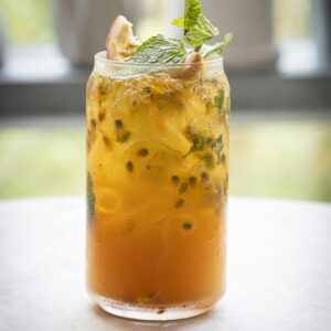 Delicious tropical mojito with mint and citrus garnish served in a transparent glass.